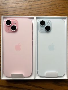 two new iphones are in the box, one is pink and one is white