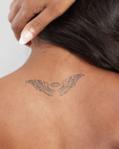 a woman with a tattoo on her back