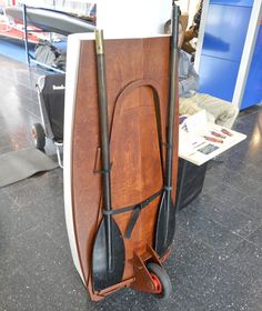 a wooden surfboard is sitting on the floor