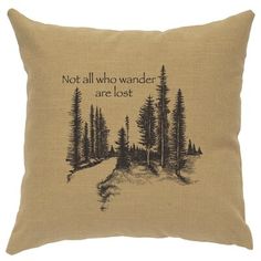 a pillow with the words not all who wander are lost on it, and trees in the background