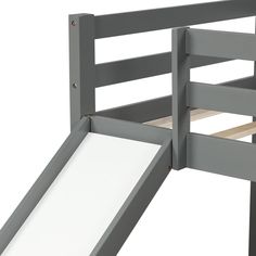 there is a gray bunk bed with a slide on the bottom and side rails down