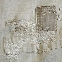 an old piece of cloth with some stitching on it