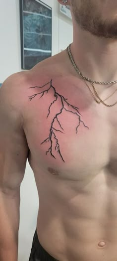 a man with a lightning tattoo on his chest