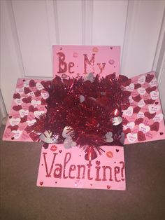 a valentine's day card is sitting on the floor next to a heart - shaped box