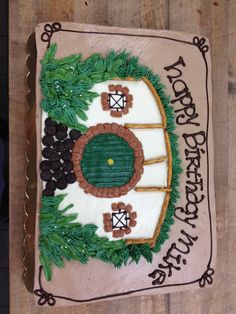 a birthday cake with an image of a baseball field and trees on it's side