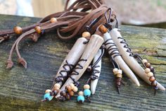 several necklaces with wooden beads and leather cord