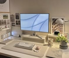 a computer monitor sitting on top of a desk next to a keyboard and mouse pad