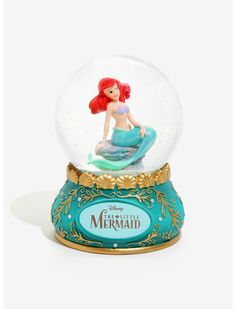 a snow globe with a little mermaid in it