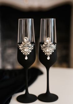 two wine glasses sitting on top of a table