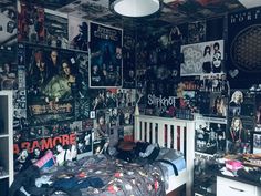 a bed room with a neatly made bed and lots of posters on the wall