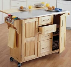 a kitchen island with drawers and plates on it