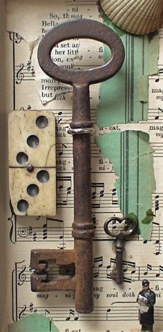 an old rusty key is on top of sheet music