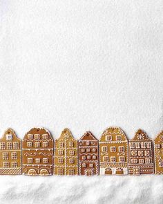 a row of gingerbread houses on a white towel