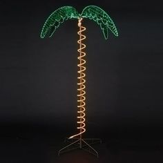 a lighted palm tree with green lights on it's top and bottom branches in the shape of spirals