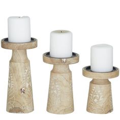 three wooden candlesticks sitting on top of each other