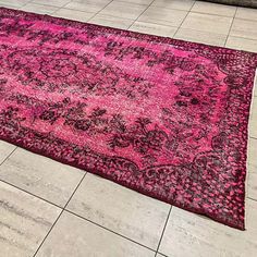 a pink and black area rug on the floor