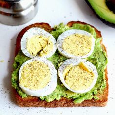 an avocado toast with hard boiled eggs on top