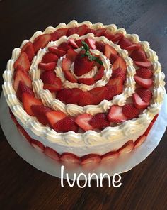 there is a large cake with strawberries on the top and words luonie above it