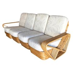 a set of three wicker sofas with cushions