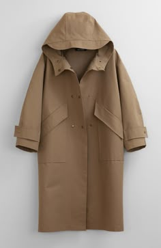 Fabric: 73% Cotton, 27% NylonColor: Light BrownCare: Hand wash / Dry clean Waterproof oversized hooded trench coat with two front pockets and centre front bottom closure. The length is 46-47 inches (118-120 cm). Unlined. Consider wearing at a temperature 68-50°F (20-10°C) Made in USA.