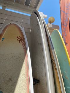 several surfboards are lined up against the wall