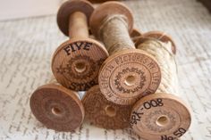 several spools of twine on top of a piece of paper with words written on them