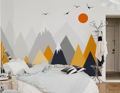 a bedroom with mountains and birds painted on the wall