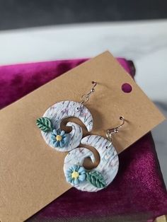 the earrings are made from polymer and have flowers on them