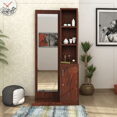 a living room with a mirror, dresser and plant in the corner on the floor