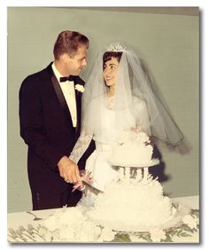 a bride and groom cutting their wedding cake