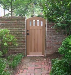 an entrance to a garden with brick walls