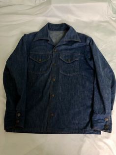 Please see pictures for measurements. All Items ship within 24 hours. FREE Shipping to all 50 states. Item Information - Up for sale is a vintage grunge style denim shirt in size large. This shirt was produced in the 1980s and does have a small tear on the back that was repaired. Please see the last picture. All items are in great condition, unless noted otherwise. You will receive the exact item pictured. Please let me know if you have any questions. Best offer option is available! My prices ar Retro Long Sleeve Denim Jacket With Buttons, Vintage Medium Wash Pre-washed Tops, Vintage Collared Dark Wash Top, Vintage Collared Top In Dark Wash, Vintage Denim Blue Button-up Top, Vintage Denim Blue Shirt For Spring, Vintage Dark Wash Tops With Buttons, Vintage Dark Wash Shirt With Pockets, Retro Denim Jacket With Snap Buttons In Medium Wash