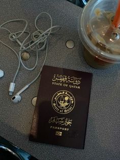 a passport sitting on top of a table next to headphones