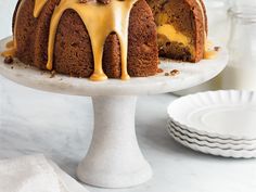 a bundt cake with icing and nuts on top