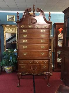 an antique wooden dresser with many drawers