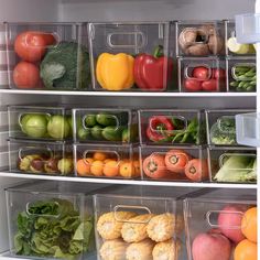 an open refrigerator filled with lots of different types of vegetables and fruits in bins