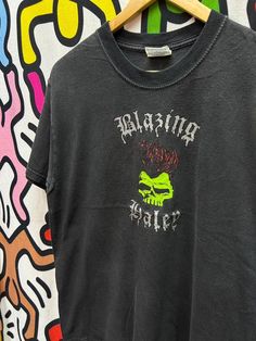 a black shirt with a green skull on it