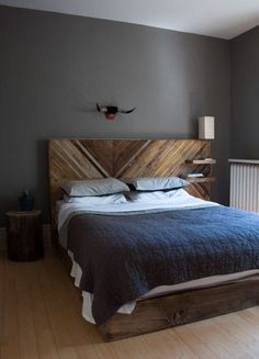 a bed sitting in the middle of a bedroom next to a wall mounted radiator