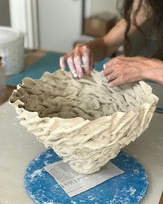 a woman is working on a sculpture in the process of making it out of clay