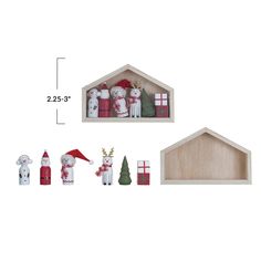 the wooden shelf is filled with christmas decorations and ornaments, including santa's house