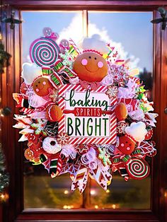 a christmas wreath with the words baking is bright on it in front of a window