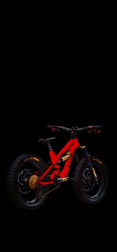 a red and black bike in the dark