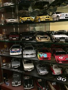 a shelf filled with lots of different types of toy cars