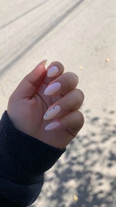 a woman's hand with pink and white nail polish