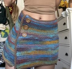 there is a woman wearing a multicolored skirt with buttons on the front and bottom