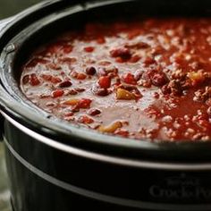 a crock pot filled with chili and beans