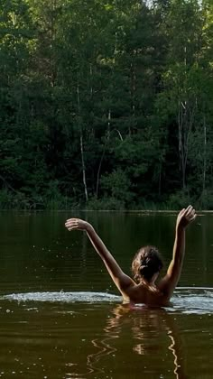 a woman swimming in the middle of a lake