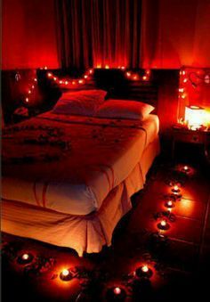 a bed with many lights on it in a room that has red walls and flooring