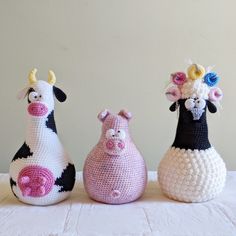 three crocheted animals sitting next to each other on top of a white table