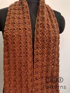 a brown knitted scarf on top of a mannequin